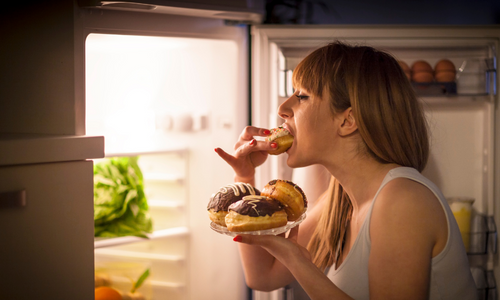 woman eating doughnuts