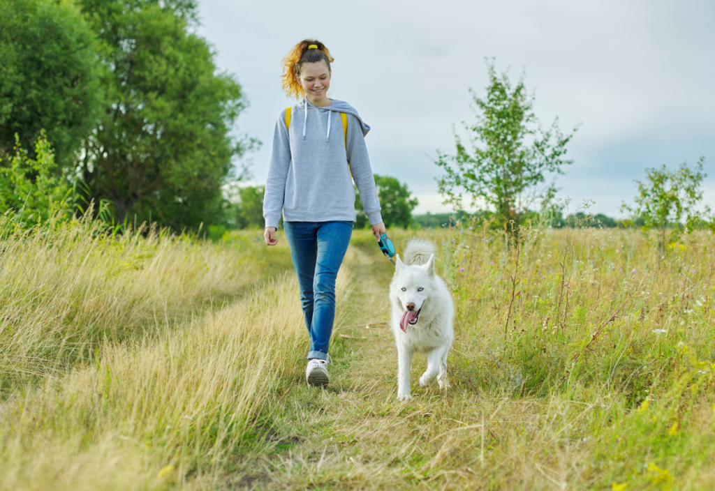 woman walking dog in park